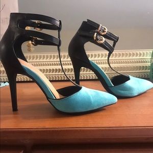 Teal and black pointed-toe heels.